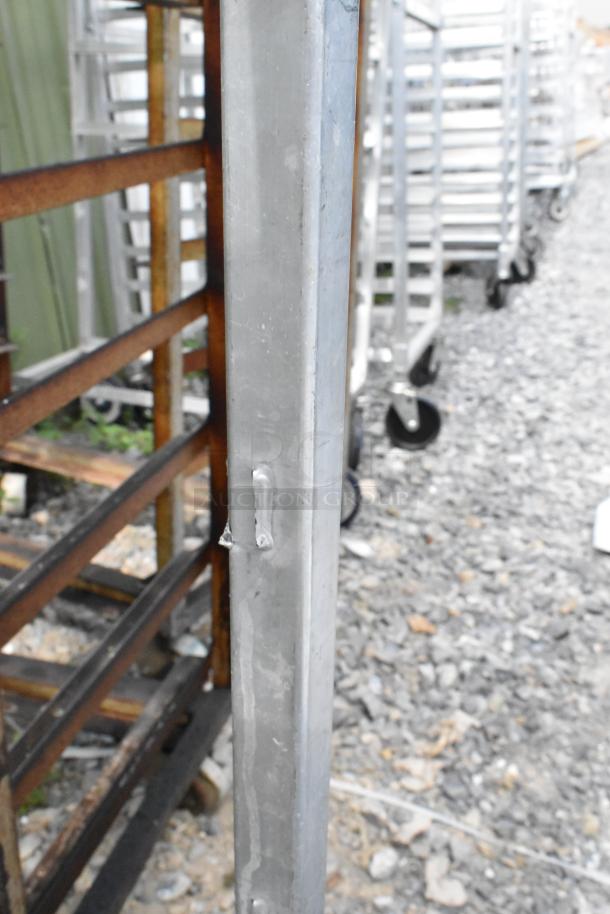 2 metal commercial pan transport racks on casters, durable and sturdy, designed for heavy-duty use, in good condition.
