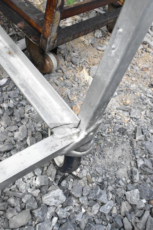 Metal commercial pan transport rack with casters, showing signs of wear and tear, labeled "2 Times Your Bid."