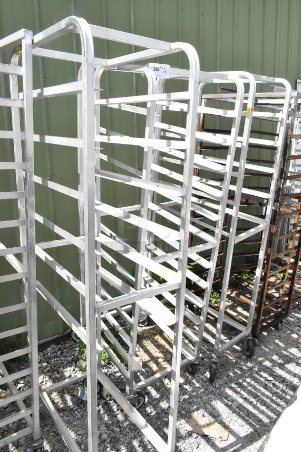 2 metal commercial pan transport racks with multiple shelves and commercial casters, in good condition.