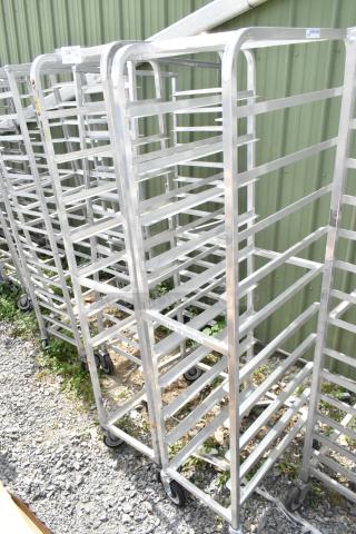 2 metal commercial pan transport racks on casters, sturdy and in good condition, ready for high-capacity use.