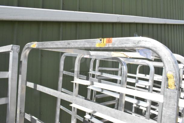 Two metal commercial pan transport racks on casters, labeled "32". Visible wear and tear, suitable for bakery or kitchen use.