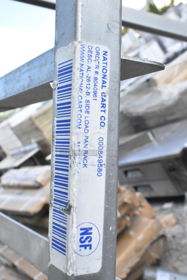 National Cart Co. metal pan transport rack on casters, side load design, NSF certified, visible wear on frame.