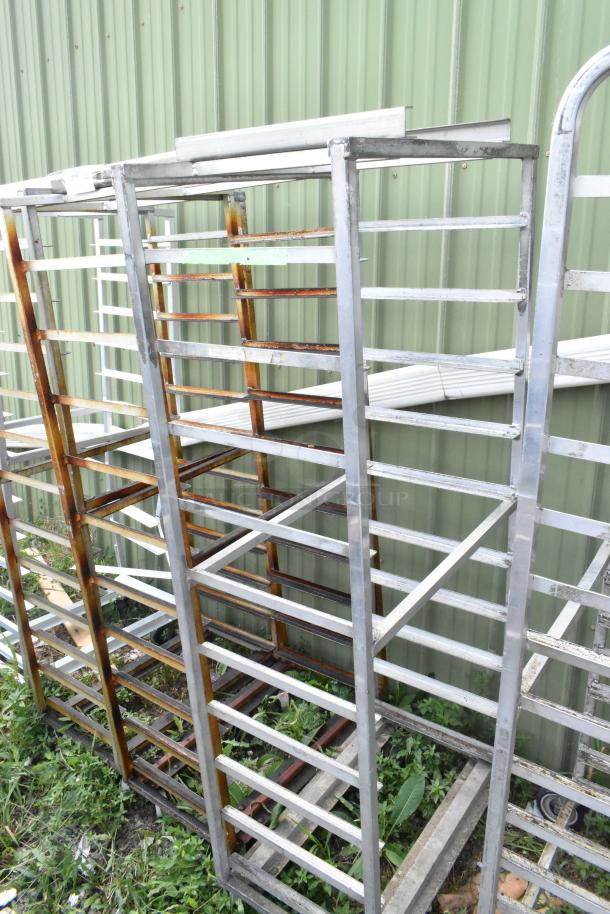 2 metal commercial pan transport racks with casters and oven guide. Some rust present. Ideal for bakery or kitchen use.
