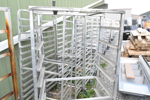 2 metal commercial pan transport racks with casters and oven guides, used condition, for efficient pan storage and transport.