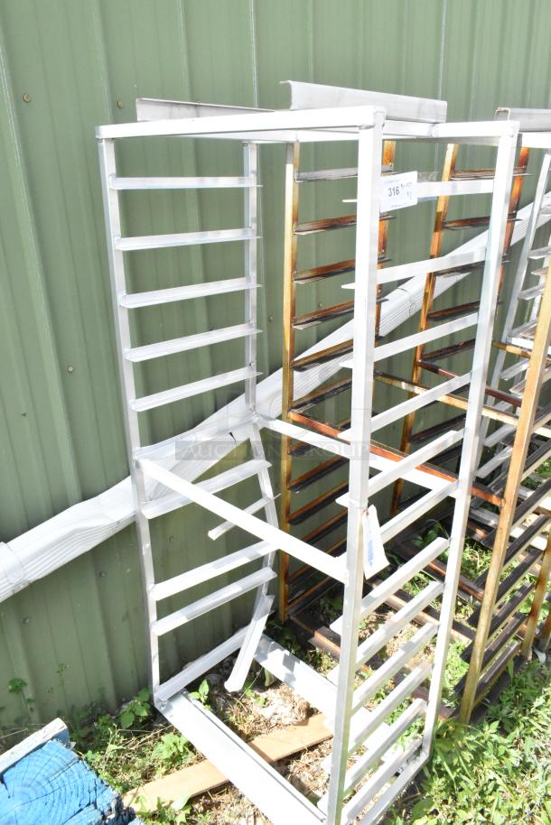 Metal commercial pan transport rack on casters with rack oven guide. Sturdy construction, ideal for kitchen use.