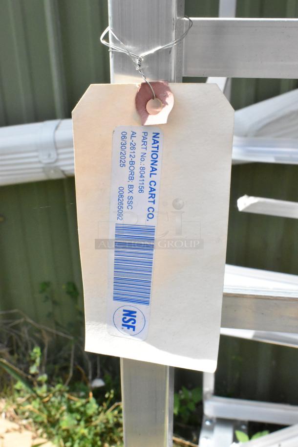 2 Metal Commercial Pan Transport Rack with oven guide on casters. Tag reads "National Cart Co.," part no. 8041156, NSF certified.