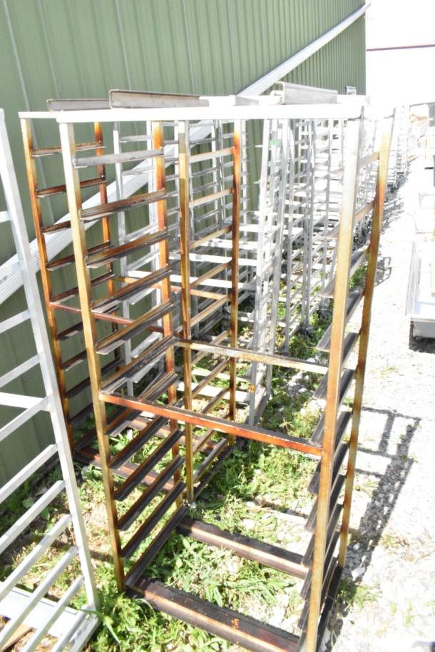 2 metal commercial pan transport racks with casters, oven guide. Used condition, suitable for catering or bakery.