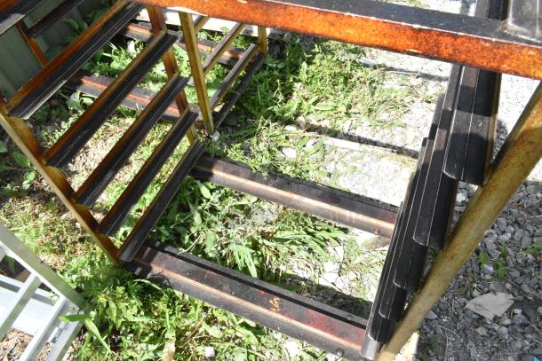 2 metal commercial pan transport racks on casters, includes rack oven guide. Rust evident, used condition.