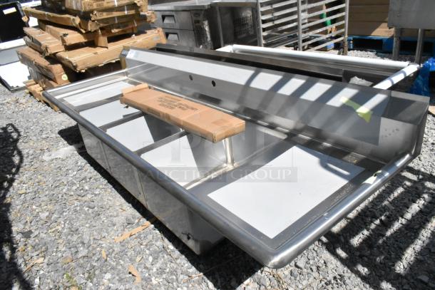 Brand new Steelton 522CS31620LR stainless steel 3 bay sink with dual drain boards, minor scratches and dents evident.