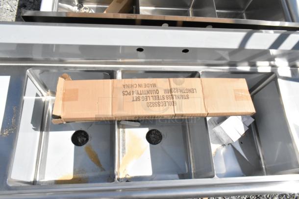 BRAND NEW Steelton 522CS31620LR Stainless Steel 3 Bay Sink with dual drain boards, slight scratches and dents visible.