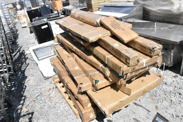 Stack of 20 new boxed items labeled "undershelf" and "patio umbrella frame," some with visible scratches and dents.