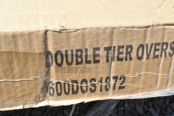 Cardboard box with "DOUBLE TIER OVERSHELF 600DOS1872" text, indicating over shelf model. Box appears slightly dented.
