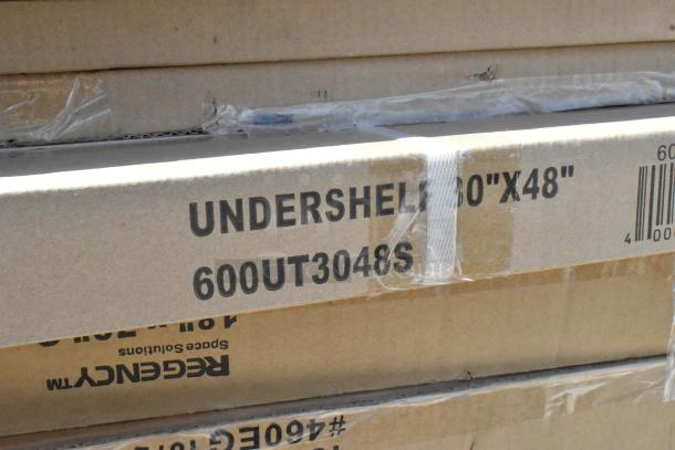 Brown cardboard boxes labeled "UNDERSHELF 60''X48'' 600UT3048S," part of scratch and dent auction items.