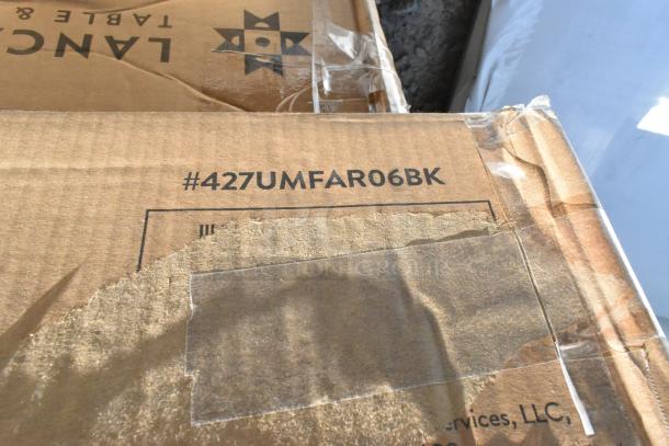 Cardboard boxes labeled #427UMFAR06BK, showing minor wear, possibly containing scratch and dent items like wire shelves and umbrella frames.