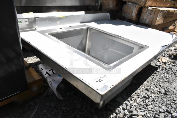 Brand new Regency 600ST3048L table with sink bay, no legs, minor scratches, durable stainless steel, NSF certified.
