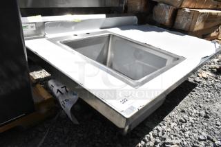 Brand new Regency 600ST3048L table with sink bay, no legs, minor scratches, durable stainless steel, NSF certified.