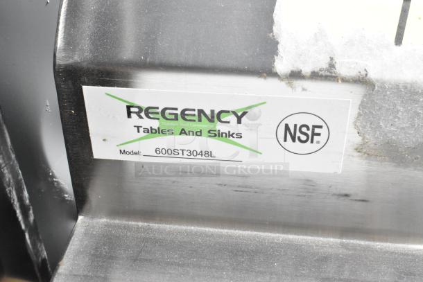 Regency 600ST3048L table with sink bay, brand new with scratches and dents, no legs, NSF certified label visible.