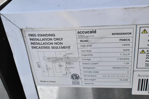 Label on Accucold FFAR23L mini cooler. Capacity: 1.7 cu.ft, voltage: 115V, refrigerant: R600a. Free-standing installation.