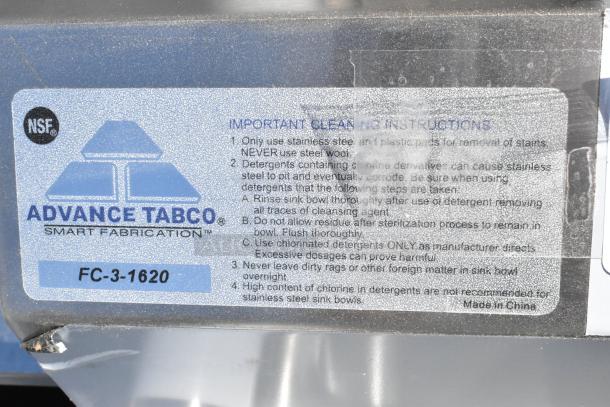 BRAND NEW Advance Tabco FC-3-1620 Stainless Steel 3 Bay Sink, scratch and dent. Cleaning instructions label visible.