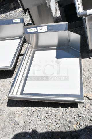 Brand new Regency 600CDT24L 2' clean dish table, 16 gauge, left drainboard, no legs, slight scratches, NSF label visible.