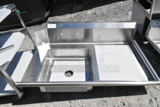 BRAND NEW Regency 600DDT48R 4' soiled dish table, right drainboard, no legs, 16-gauge steel, minor scratches visible.