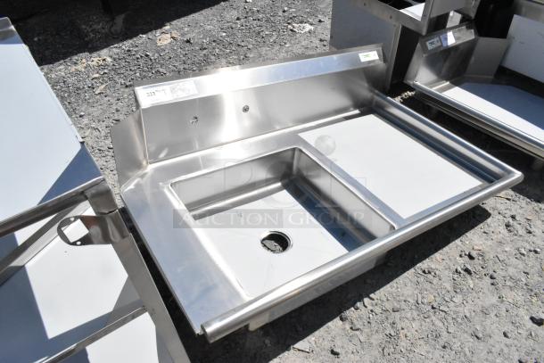 BRAND NEW Regency 600DDT48R 16 Gauge 4' soiled dish table with right drainboard, no legs, visible scratches.