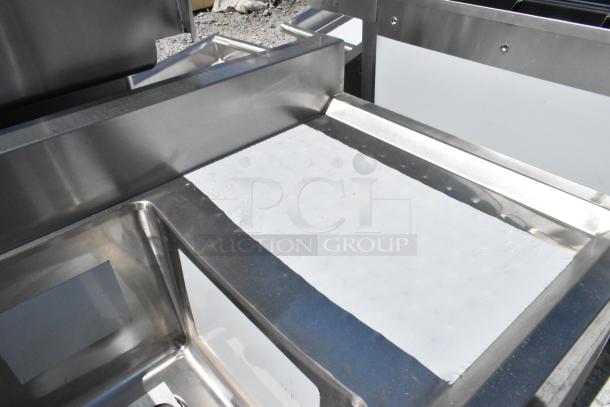 BRAND NEW Regency stainless steel 3 bay back bar sink with dual drain boards, slight scratches visible.