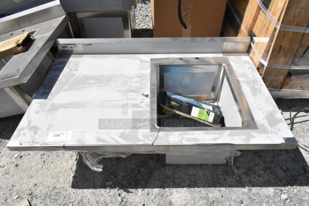 Brand new Regency 600ST3048R stainless steel table with sink bay, scratch and dent, no legs, visible packaging.