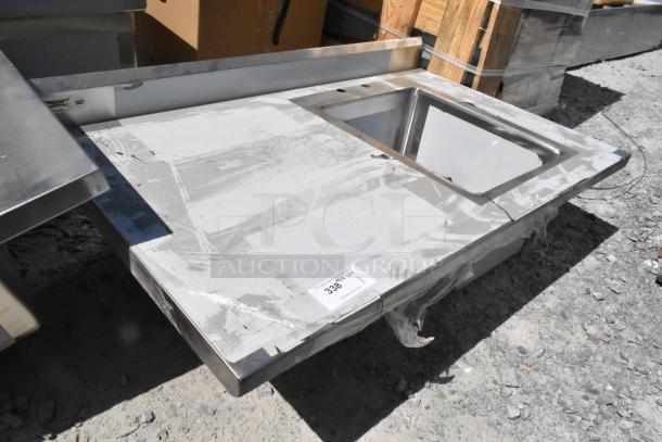 BRAND NEW Regency 600ST3048R stainless steel table with sink bay, no legs, scratch and dent condition, label visible.