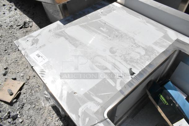 BRAND NEW SCRATCH AND DENT! Regency 600ST3048R stainless steel table with sink bay; no legs; scratch marks visible; includes label showing "328 4 ft. Qty: 1".