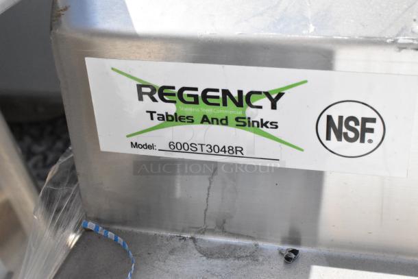 Regency 600ST3048R stainless steel table with sink bay, scratch and dent, no legs, NSF certified label visible.