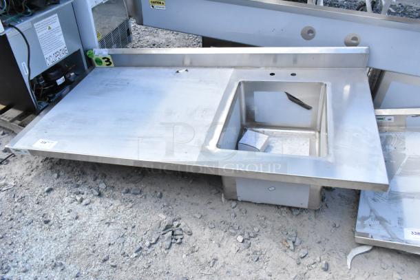 Brand new Regency 600ST3060R stainless steel table with sink bay, scratch and dent condition. Visible markings indicate model.