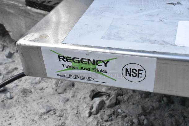 Regency 600ST3060R stainless steel table with sink bay, brand new condition, scratch and dent, NSF certified label visible.