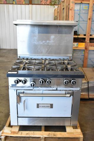 Brand new Garland G36-6 stainless steel commercial 6-burner range with oven, over shelf, back splash; minor scratches and dents visible.