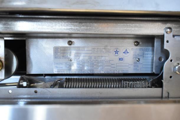 Label on Garland G36-6R commercial range indicates gas model, serial number, and NSF certification details.
