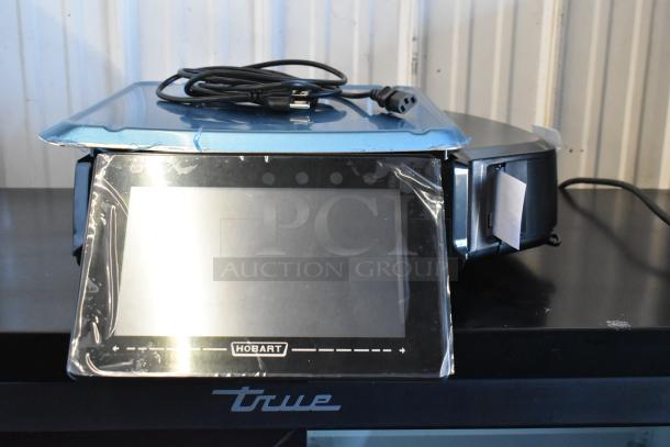 Brand new 2024 Hobart HTi commercial countertop food portioning scale, in box, with plastic cover. 120/208-240V, 1 Phase.
