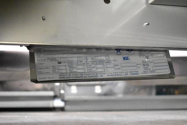 Brand new 2025 Garland GTGG72-672M stainless steel propane gas griddle with scratch and dent. Model and specs label shown.