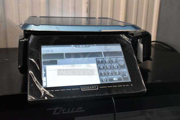 Alt Text: 2024 Hobart HTi metal commercial countertop food portioning scale, touchscreen, new with protective film, 120/208-240V.