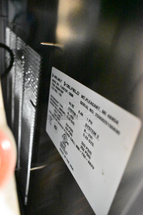 Label on Delfield F18DC72P-DOM stainless steel prep table. Shows model and technical specs, includes voltage and phase info.