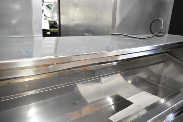 Brand new 2025 Delfield F18DC72P-DOM stainless steel commercial prep table with superficial scratches. On commercial casters.