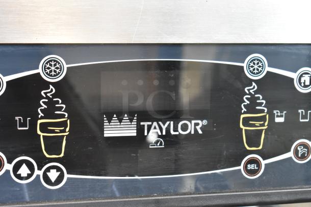 Taylor C723-33 soft serve ice cream machine control panel, featuring digital display and operation icons. Stainless steel finish.