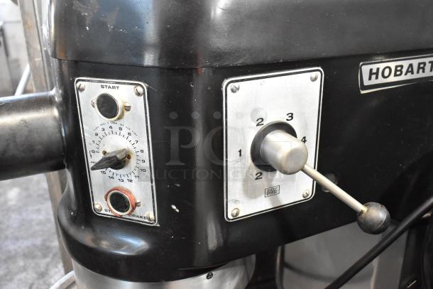 Hobart L-800 metal commercial dough mixer with control knobs visible, in working condition. Includes bowl and attachments.