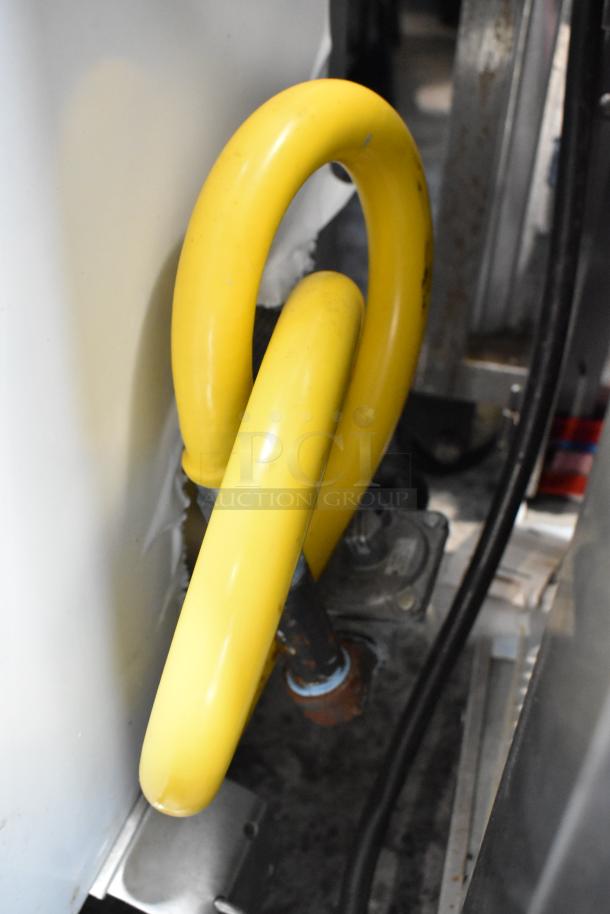 Toastmaster TCT-1627 R tandoor oven; stainless steel, natural gas, on casters, 85,500 BTU. Close-up of yellow gas line.