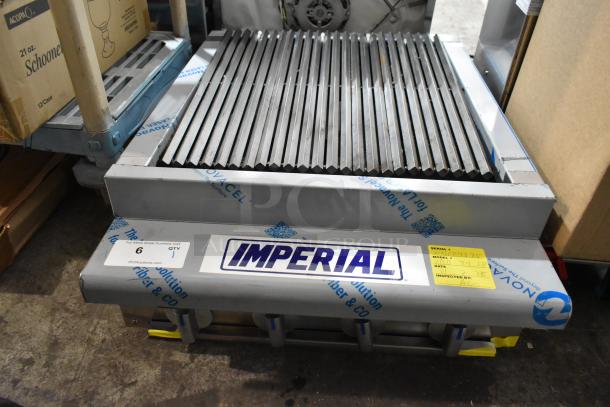 Brand new Imperial IRB-24 stainless steel 24" propane charbroiler, minor cosmetic dents. Model details visible on label.