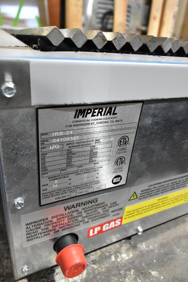 Brand new scratch and dent Imperial IRB-24 stainless steel 24" liquid propane countertop charbroiler, serial 04109325, with safety labels.