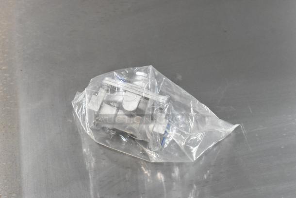 Brand new Vollrath GGMDM-36 stainless steel griddle component in sealed bag, on countertop. Scratch and dent condition.