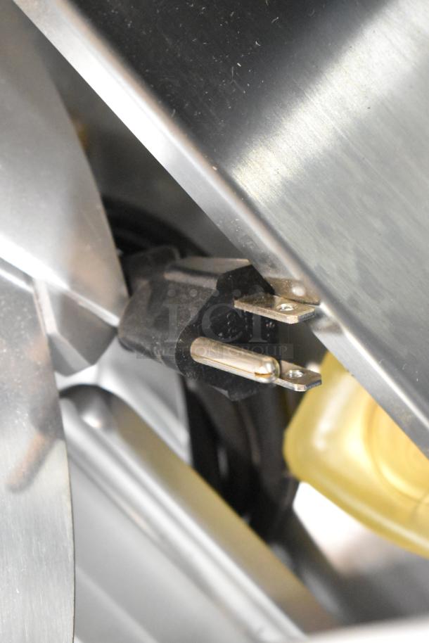 Alt text: Close-up of plug on Estella 348SLAS13 stainless steel meat slicer. 120 volts, scratch and dent condition.