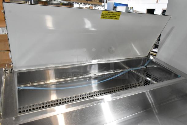 Avantco 2025 178SSPPT3 stainless steel commercial pizza prep table, new, scratch and dent, with label indicating pan usage for temperature maintenance.