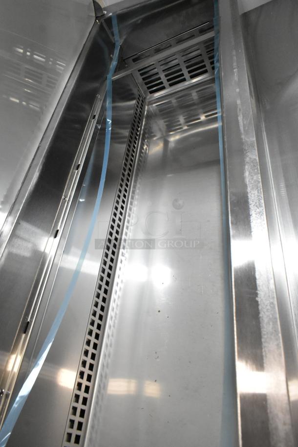 Brand new Avantco 178SSPPT3 stainless steel pizza prep table interior, showing scratch and dent condition with clean surfaces.