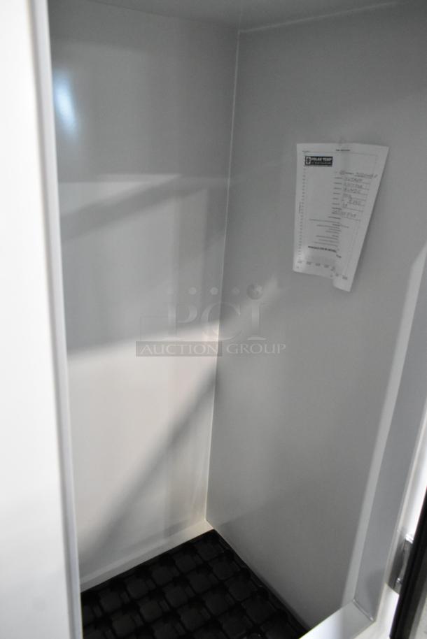 Alt text: Polar Temp 300 CWGP Cold Wall Ice Merchandiser, 30 cu. ft., new with minor scratches, interior view, label attached.